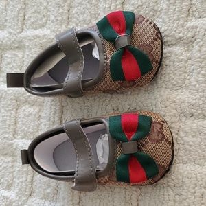 Gucci print baby girl shoes 4.5 inches in length. I would guess around 9 month o